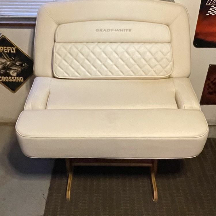 White upholstered bench seat mounted on a metal base